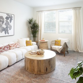 Relax and unwind in stylish living spaces	 living room with a couch, chairs and large window