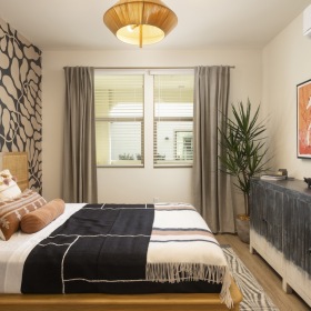 Relax and recharge in beautiful and spacious bedrooms bedroom with a large dresser and plant